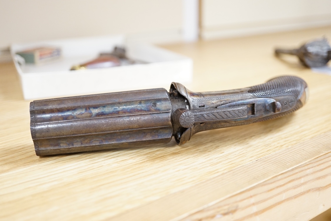A six shot 80 bore, self-cocking, pepperbox revolver signed; W. Dooley, Liverpool, with foliate engraved frame and fluted barrel, Birmingham proved, and one piece rounded chequered walnut grip, together with a small copp